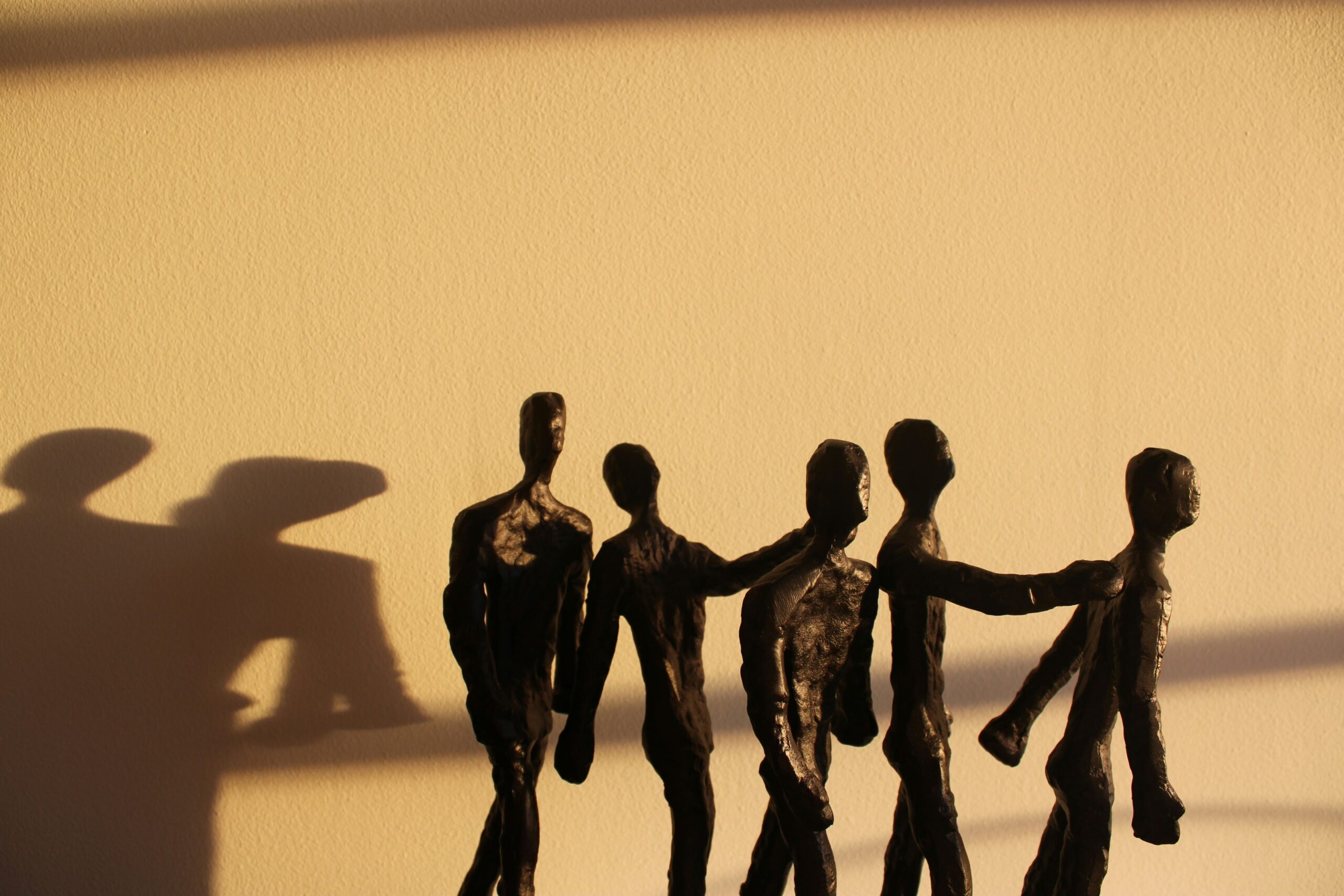 Community silhouettes at sunset — unity and dignity